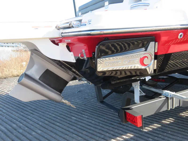 Slide: The Image of 2024 Chaparral 23 Surf boat stern with propulsion system and trailer. - 2