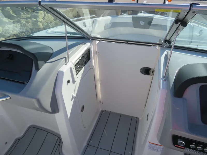 Slide: The Image of 2024 Chaparral 23 Surf boat interior with open windshield and seating area. - 20