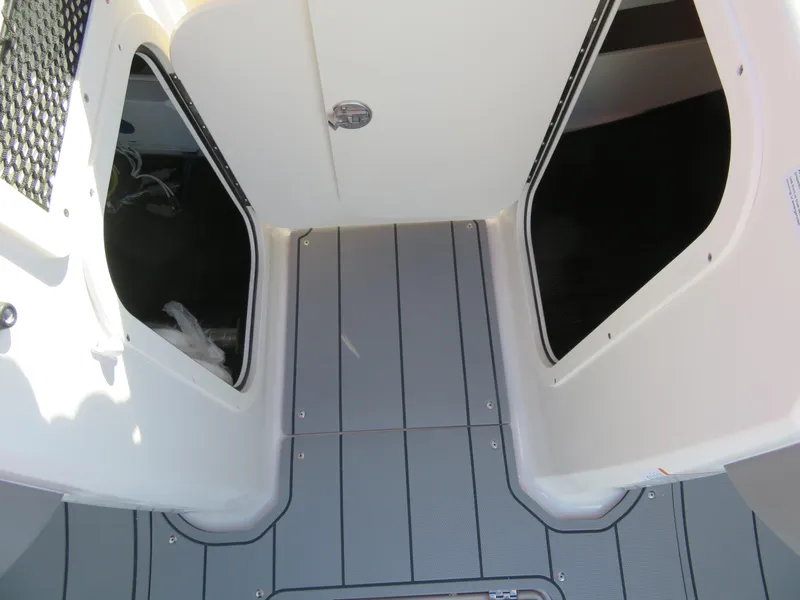 Slide: The Image of 2024 Chaparral 23 Surf boat interior storage compartments and deck. - 21