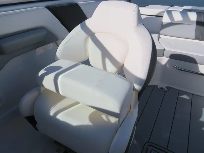 Slide: The Image of 2024 Chaparral 23 Surf boat interior with white captain's chair. - 22