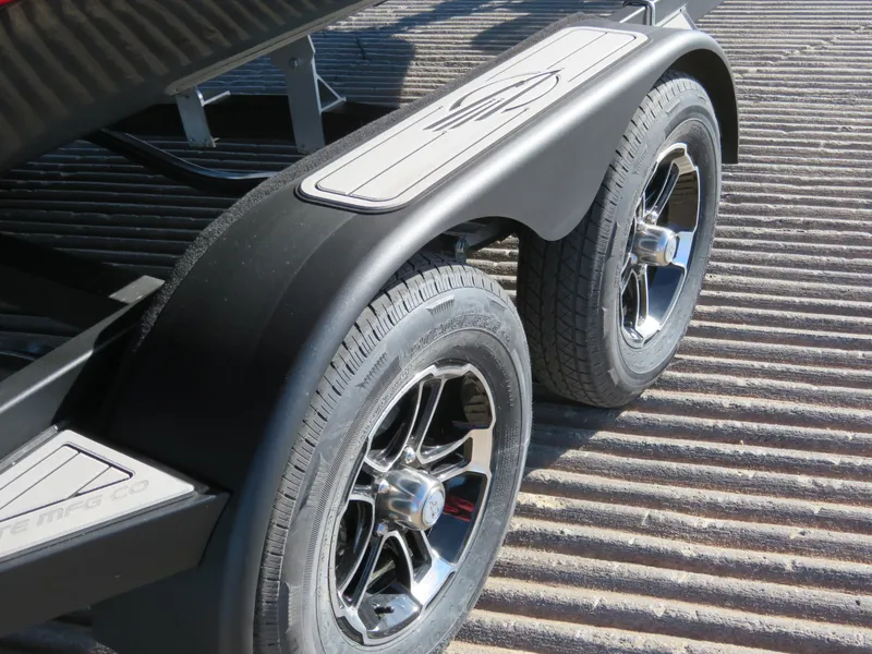 Slide: The Image of 2024 Chaparral 23 Surf boat trailer with dual wheels and stylish rims. - 3