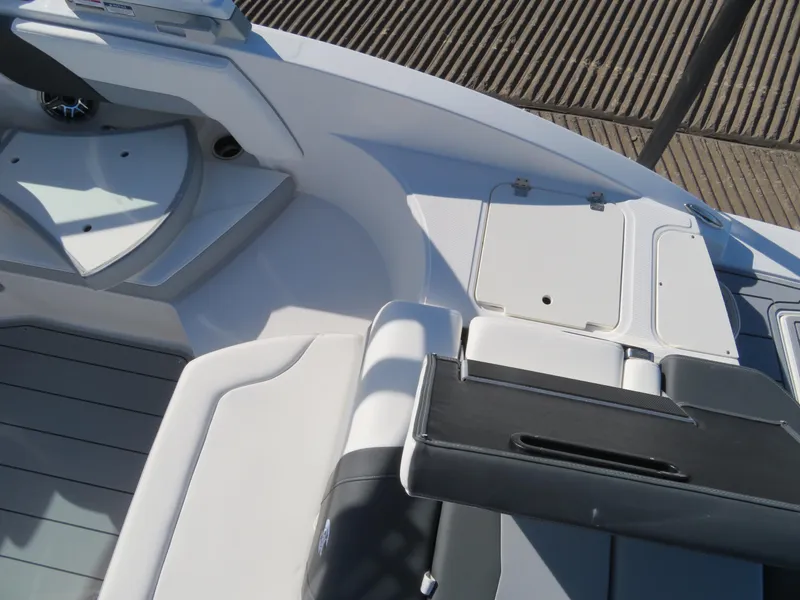 Slide: The Image of 2024 Chaparral 23 Surf boat interior with white and black seating. - 6
