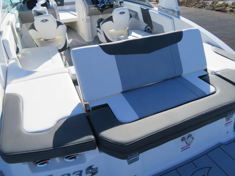 Slide: The Image of 2024 Chaparral 23 Surf boat interior with white and gray seating. - 7