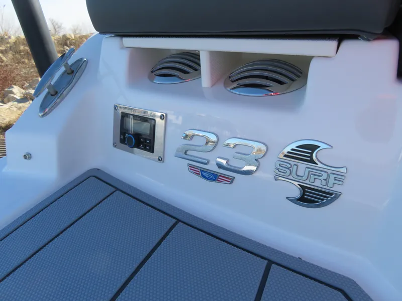 Slide: The Image of 2024 Chaparral 23 Surf boat interior with logo and control panel. - 9