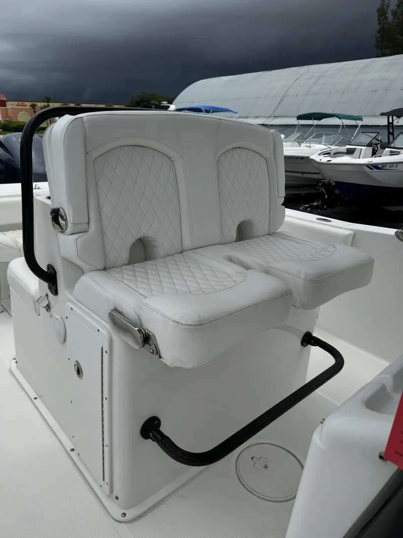 Slide: The Image of 2019 Sea Hunt Gamefish 27 Forward Seating boat with white cushioned seats. - 20