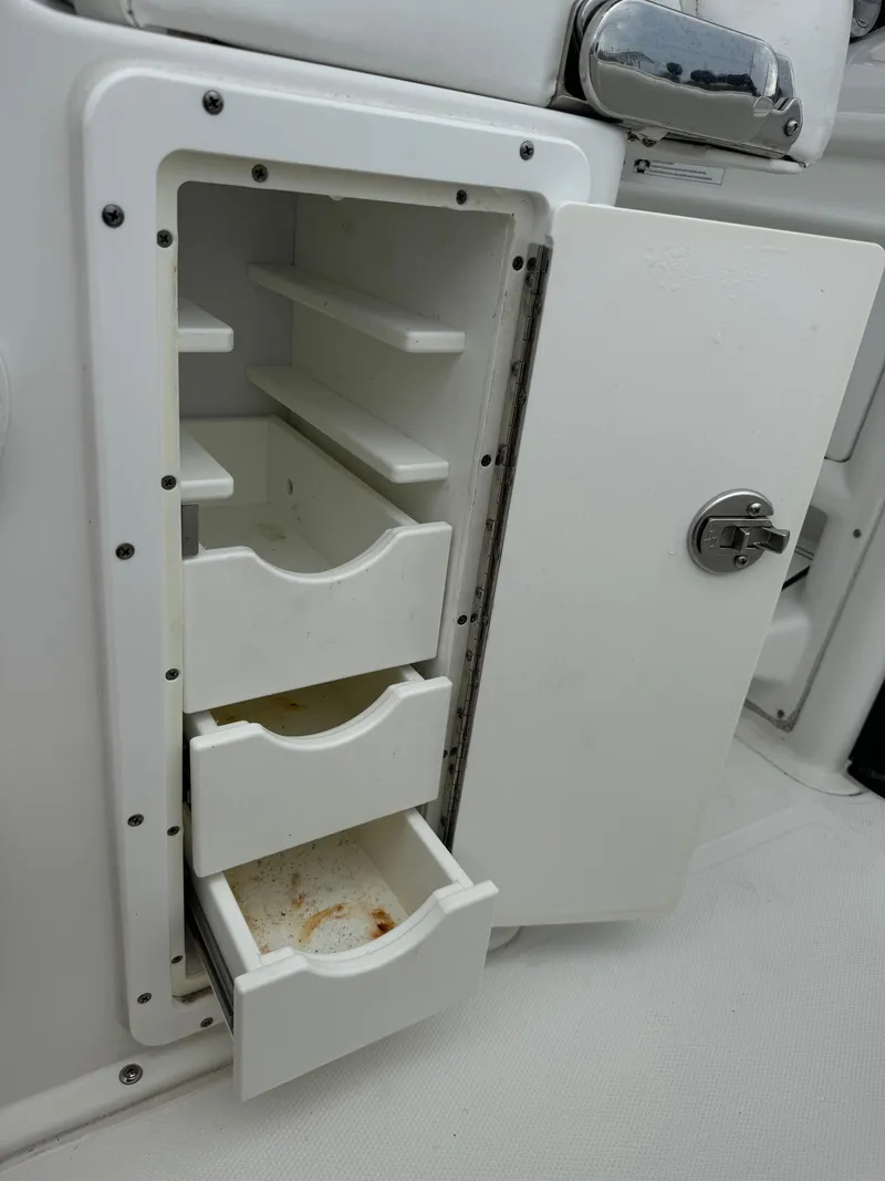 Slide: The Image of 2019 Sea Hunt Gamefish 27 Forward Seating storage compartment with open drawers. - 32