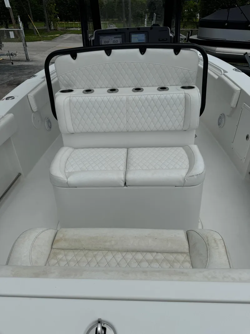 Slide: The Image of 2019 Sea Hunt Gamefish 27 Forward Seating boat with white cushioned seats. - 34