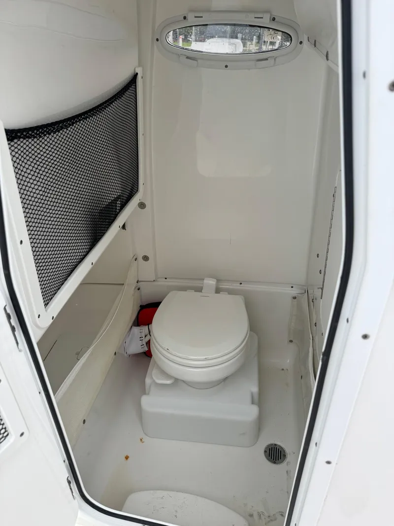 Slide: The Image of 2019 Sea Hunt Gamefish 27 Forward Seating boat interior with toilet. - 41
