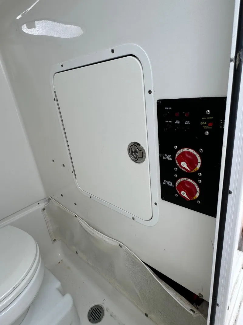 Slide: The Image of 2019 Sea Hunt Gamefish 27 Forward Seating boat interior control panel and storage compartment. - 43