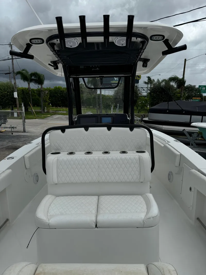 Slide: The Image of 2019 Sea Hunt Gamefish 27 Forward Seating boat with white cushioned seats. - 5