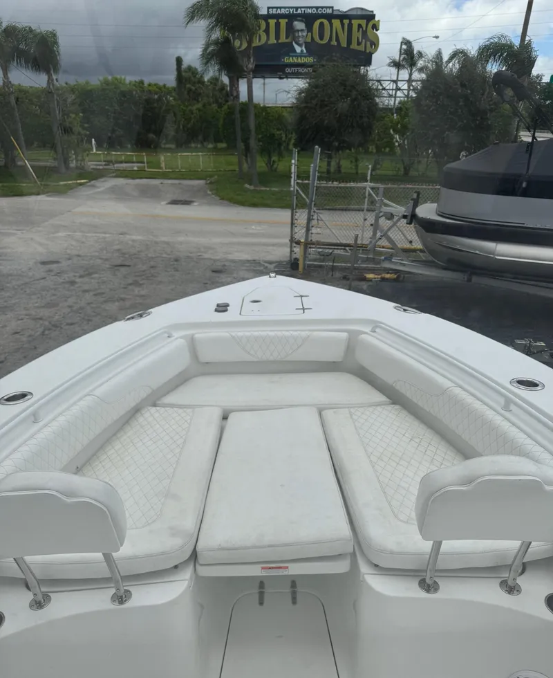 Slide: The Image of 2019 Sea Hunt Gamefish 27 Forward Seating boat with white cushioned seats. - 6