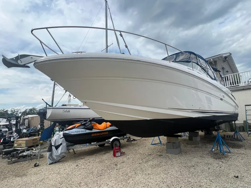 Slide: The Image of 2002 Sea Ray 300 Sundancer boat on stands in a marina. - 1