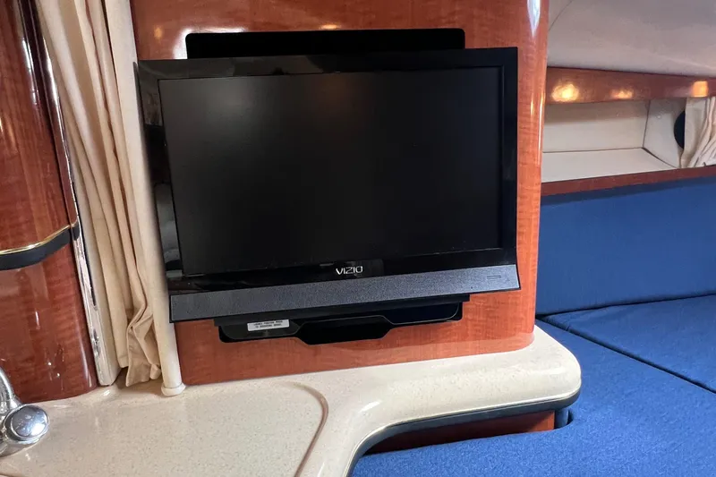 Slide: The Image of Flat-screen TV in the cabin of a 2002 Sea Ray 300 Sundancer boat. - 22