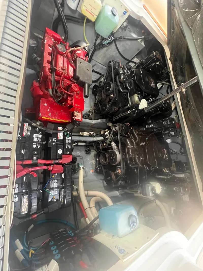Slide: The Image of Engine compartment of a 2002 Sea Ray 300 Sundancer boat showing batteries and engine components. - 26
