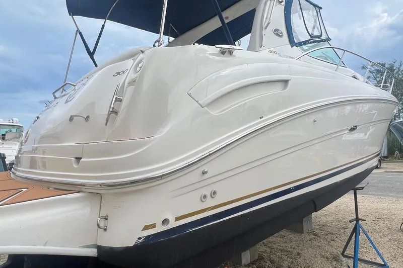 Slide: The Image of 2002 Sea Ray 300 Sundancer boat on dry dock, side view. - 3