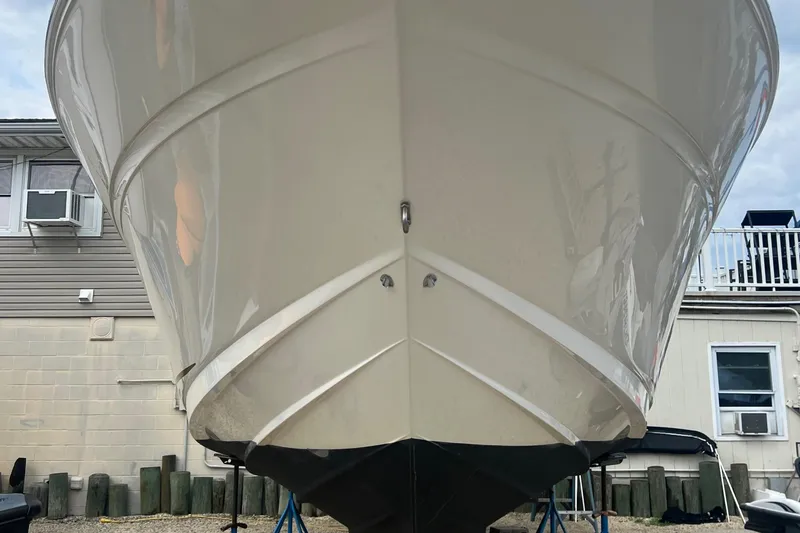Slide: The Image of Front view of a 2002 Sea Ray 300 Sundancer boat on dry dock. - 4