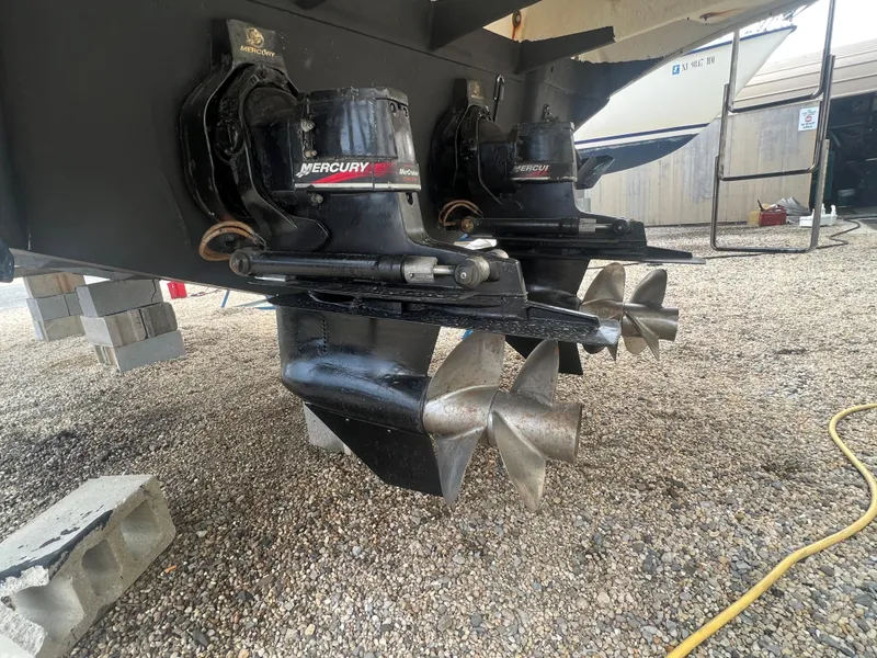 Slide: The Image of 2002 Sea Ray 300 Sundancer with twin Mercury outdrives on gravel. - 8