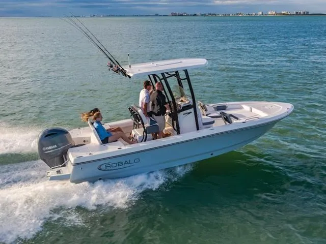 Slide: The Image of 2024 Robalo 226 Cayman boat cruising on open water. - 24