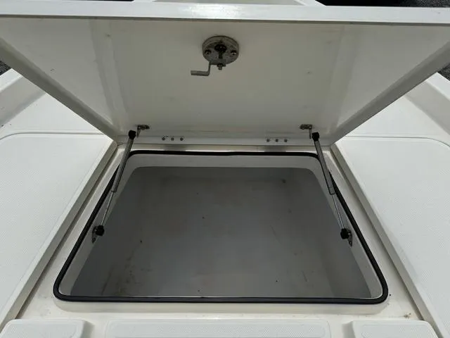 Slide: The Image of Open storage compartment of a 2021 Skeeter SX210 boat. - 12