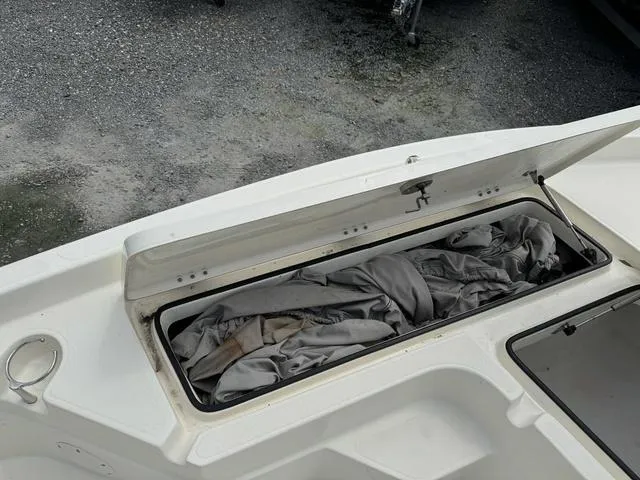 Slide: The Image of 2021 Skeeter SX210 boat storage compartment with cover inside. - 13