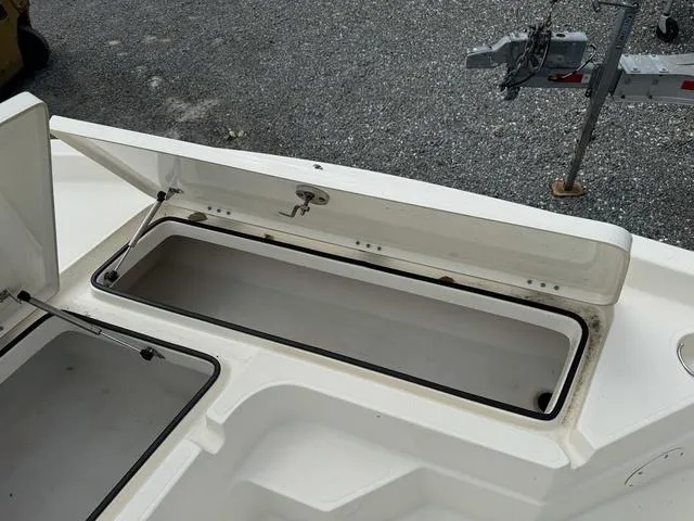 Slide: The Image of 2021 Skeeter SX210 boat storage compartment with open lid. - 14
