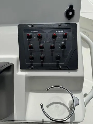 Slide: The Image of Control panel of a 2021 Skeeter SX210 boat with various switches. - 23