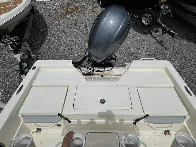 Slide: The Image of 2021 Skeeter SX210 boat stern with outboard motor and storage compartments. - 24