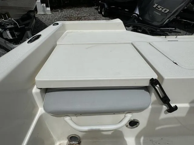 Slide: The Image of 2021 Skeeter SX210 boat seating and storage compartment. - 25