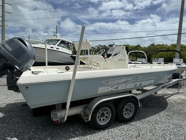 Slide: The Image of 2021 Skeeter SX210 boat on a trailer in a marina. - 4
