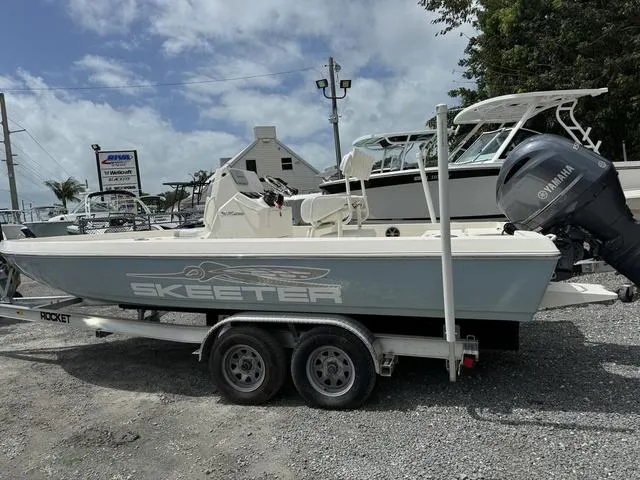 Slide: The Image of 2021 Skeeter SX210 boat on a trailer with Yamaha outboard motor. - 6