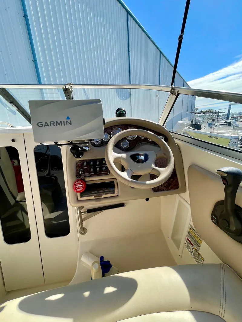 Slide: The Image of 2001 Stingray 240 CS boat cockpit with Garmin navigation system. - 4
