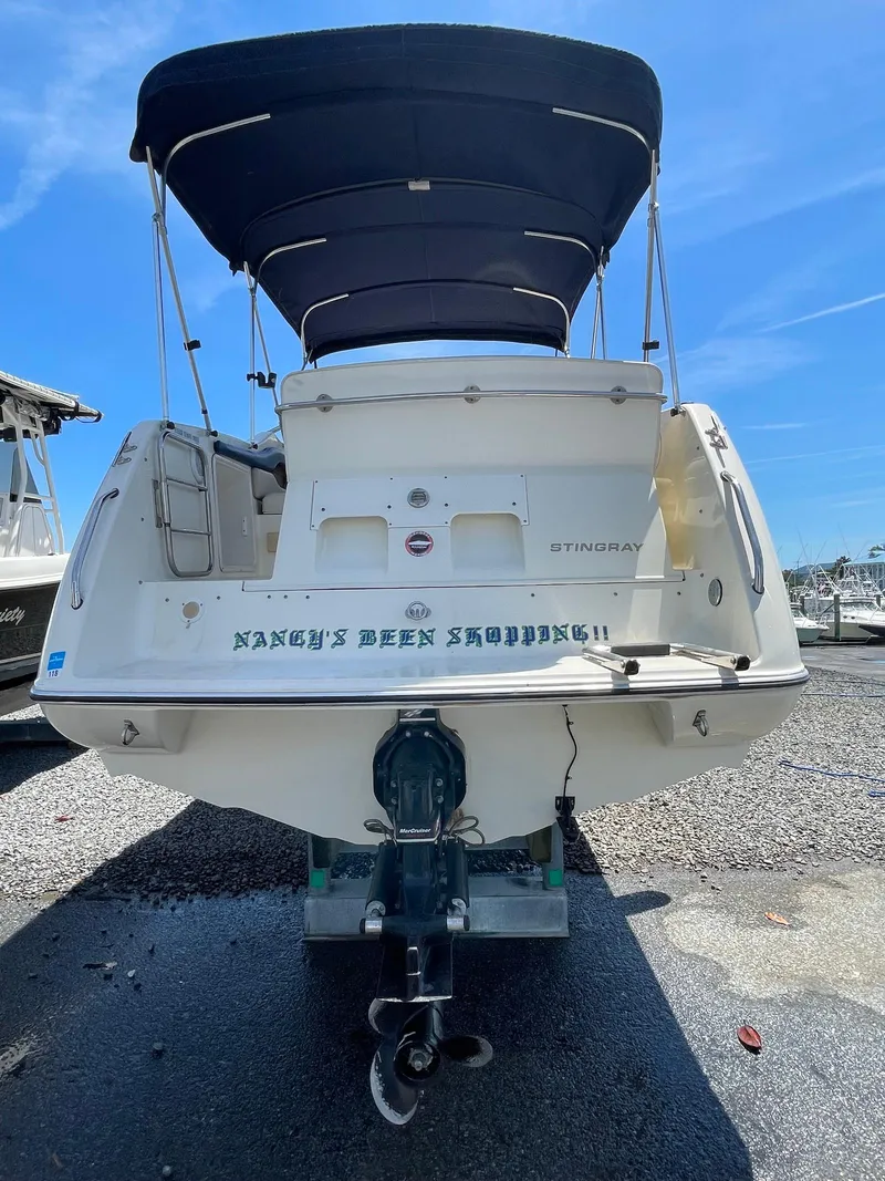 Slide: The Image of 2001 Stingray 240 CS boat with canopy, docked on a sunny day. - 7