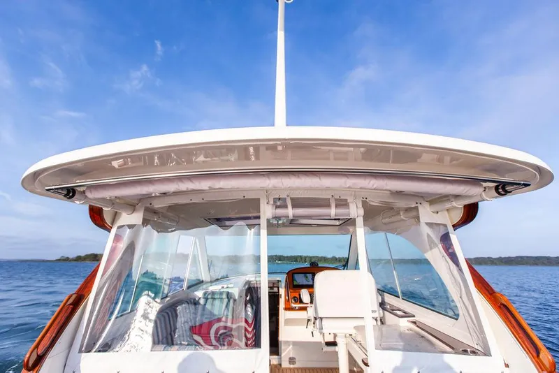 Slide: The Image of Steering wheel of 2022 Hinckley Sport Boat 40 X with modern dashboard controls. - 15