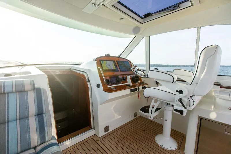 Slide: The Image of 2022 Hinckley Sport Boat 40 X cockpit with modern controls and seating. - 18