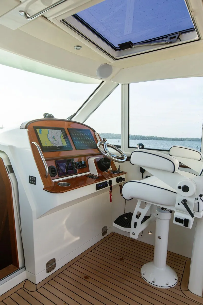 Slide: The Image of Interior of 2022 Hinckley Sport Boat 40 X with helm and seating. - 19