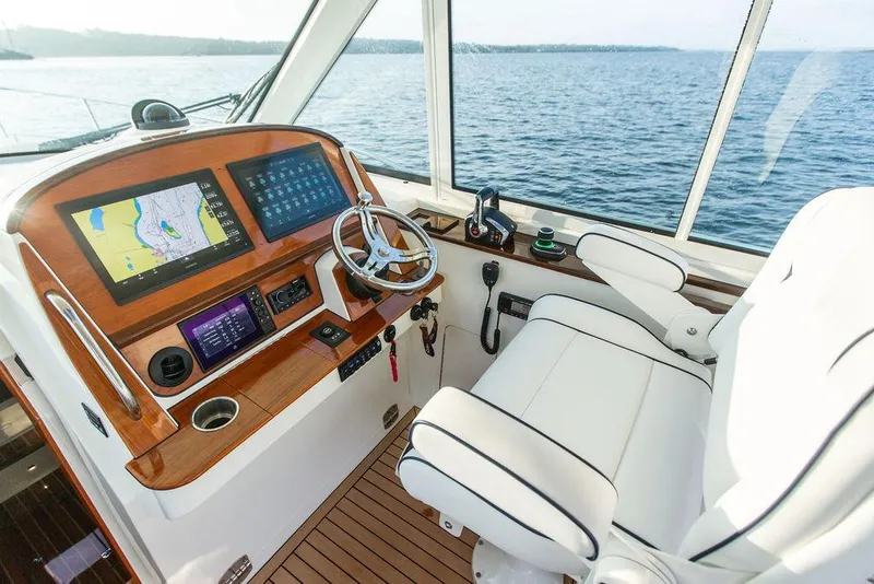 Slide: The Image of Interior detail of 2022 Hinckley Sport Boat 40 X, featuring white seating and table. - 23