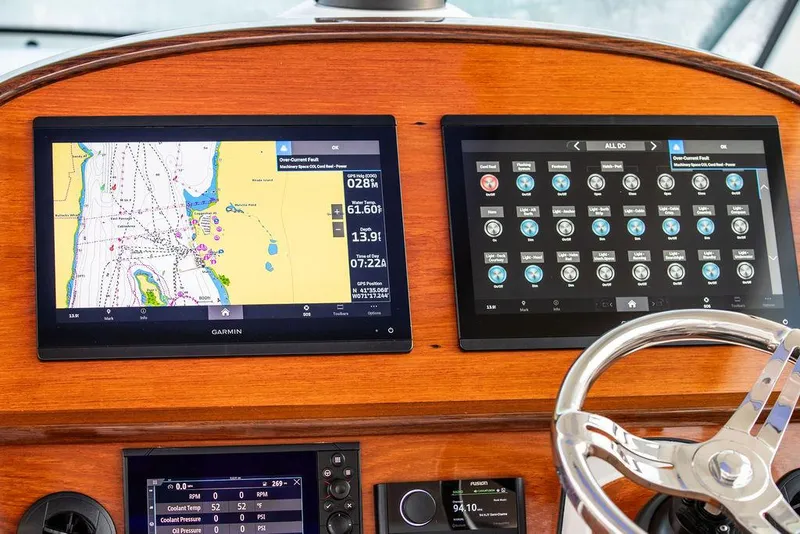 Slide: The Image of Hinckley Sport Boat 40 X 2022 with striped seating and American flag on teak deck. - 26