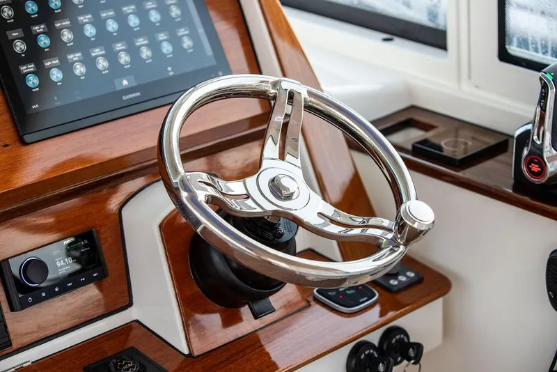 Slide: The Image of 2022 Hinckley Sport Boat 40 X with American flag on open water. - 28