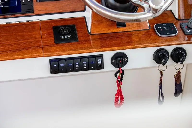 Slide: The Image of 2022 Hinckley Sport Boat 40 X interior with striped seating and wooden deck. - 29