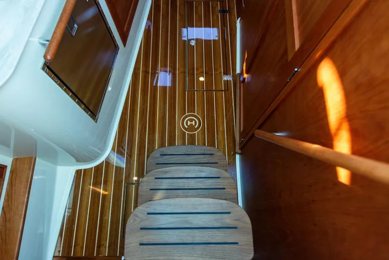 Slide: The Image of 2022 Hinckley Sport Boat 40 X nameplate on polished wood surface. - 42