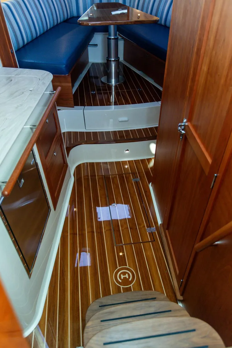 Slide: The Image of Interior view of 2022 Hinckley Sport Boat 40 X with polished wood flooring. - 50