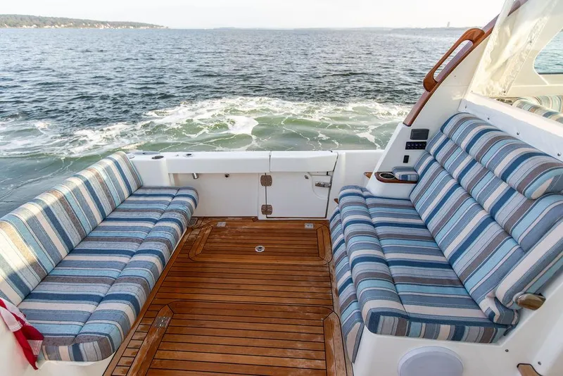 Slide: The Image of Hinckley Sport Boat 40 X 2022 dashboard with navigation screens and steering wheel. - 9