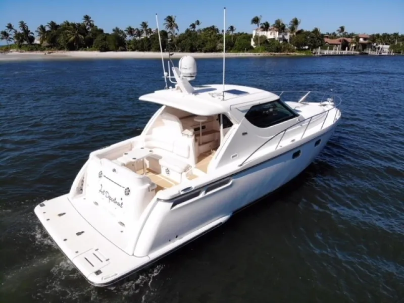Slide: The Image of 2006 Tiara Yachts 4300 Sovran Express Cruiser on the water near a tropical shoreline. - 37
