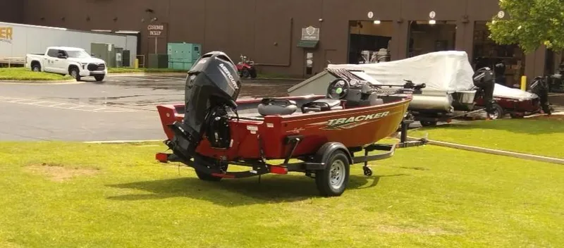Slide: The Image of 2024 Tracker Super Guide V-16 SC boat on trailer, parked on grass. - 3