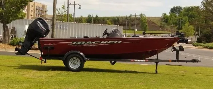Slide: The Image of 2024 Tracker Super Guide V-16 SC boat on trailer, parked on grass. - 4
