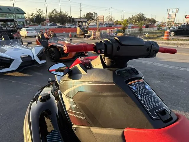 Slide: The Image of 2024 Yamaha Marine Waverunner EX SPORT in black and cyan, parked outdoors with vehicles nearby. - 10