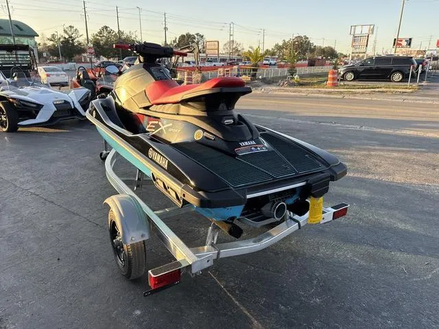 Slide: The Image of 2024 Yamaha Marine Waverunner EX SPORT in black and cyan on a trailer. - 12