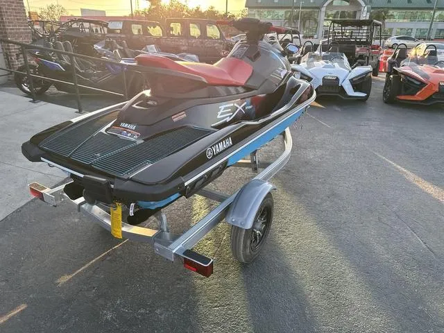 Slide: The Image of 2024 Yamaha Marine Waverunner EX SPORT in black and cyan on a trailer. - 7