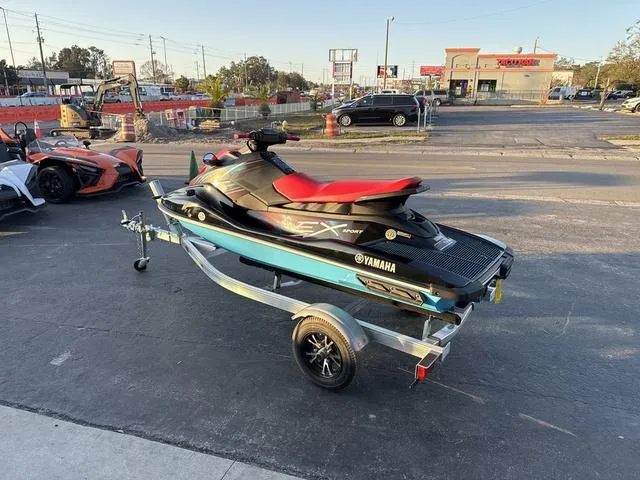 Slide: The Image of 2024 Yamaha Marine Waverunner EX SPORT in black and cyan on a trailer in a parking lot. - 8