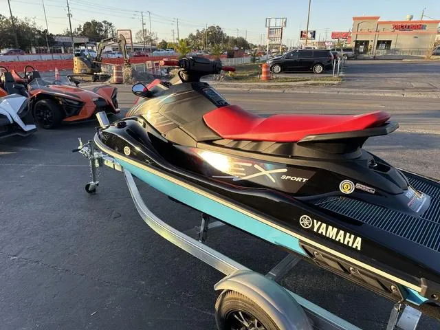 Slide: The Image of 2024 Yamaha Marine Waverunner EX SPORT in black and cyan on a trailer. - 9